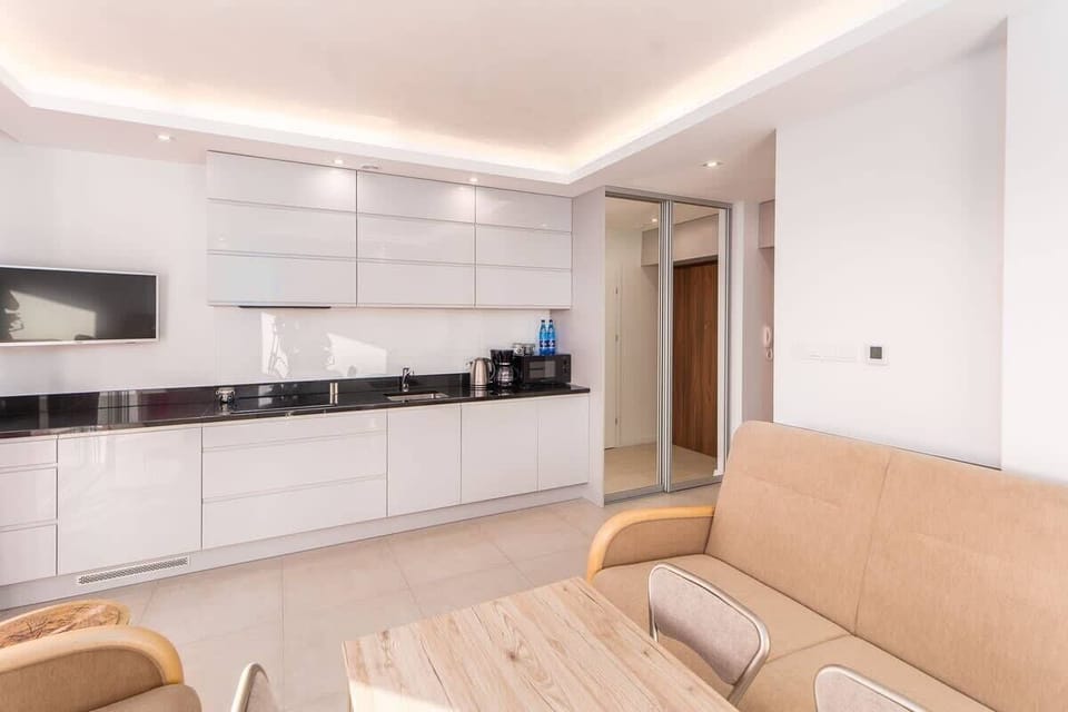 Bright kitchen with cooking utensils. 