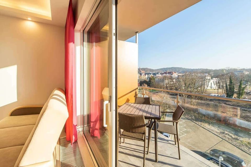 Spacious balcony with outdoor furniture. 