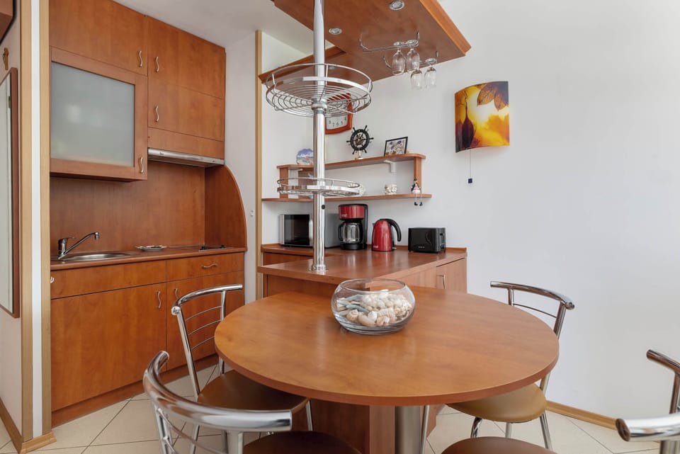 Kitchenette and dining table with chairs.