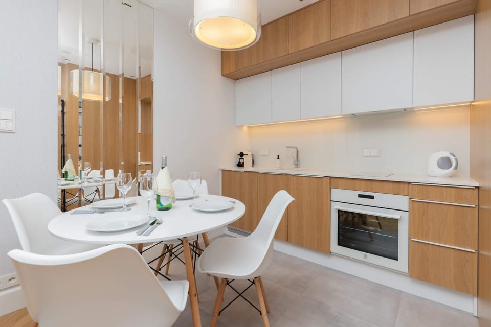 The spacious living area features a comfortable sofa bed and a flat-screen television.