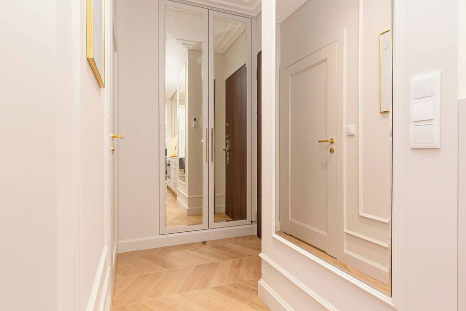 Hallway with closet and mirror.