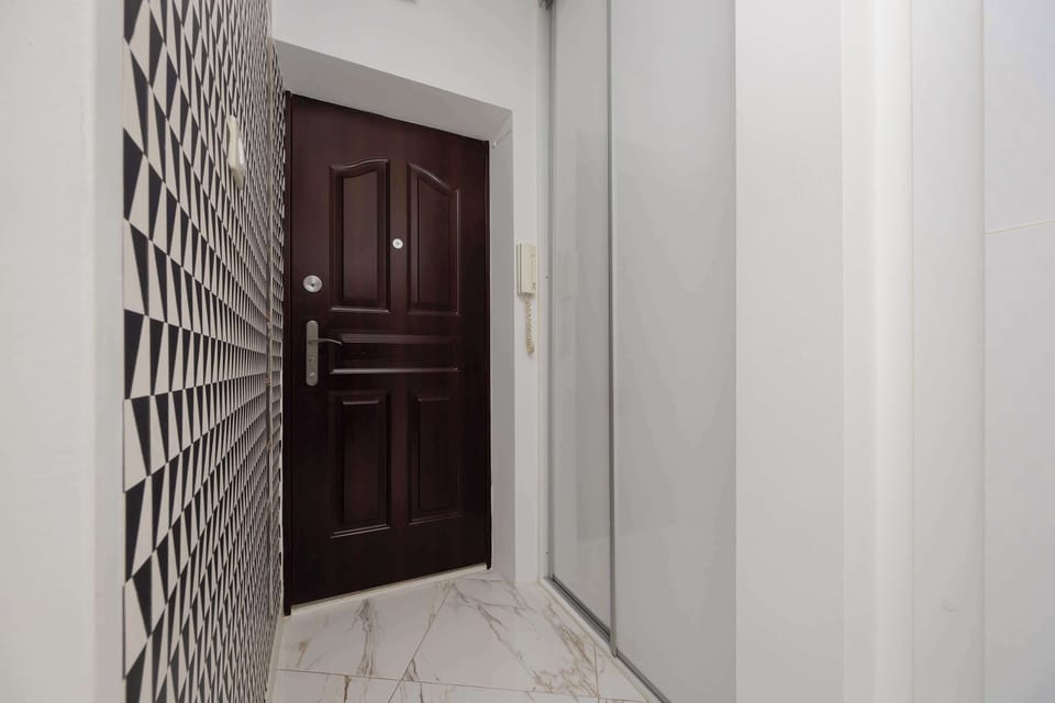 The entrance door with an intercom ensures privacy and security during your stay.