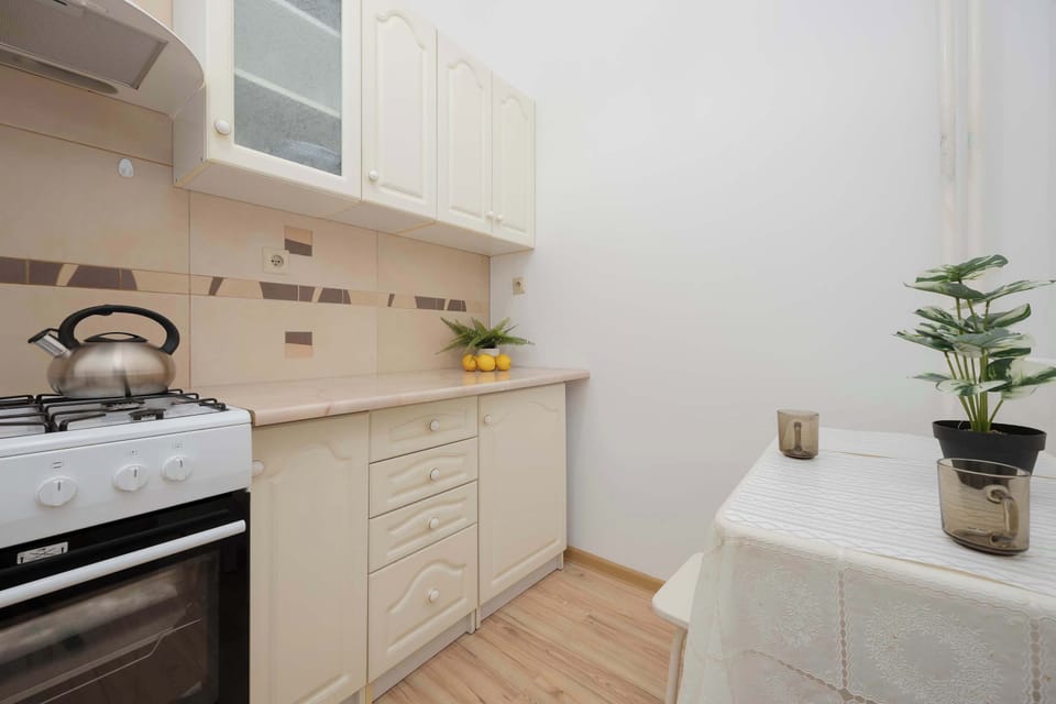 Fully equipped kitchen with gas stove and dining area.