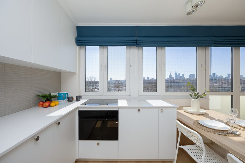 A bright kitchen that provides natural light and cooking space thanks to large windows.