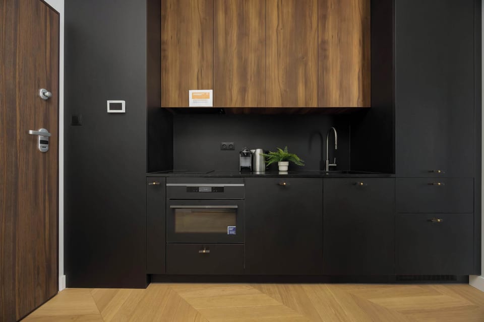 The stylish kitchen with dark cabinets and wooden finishes makes cooking during your stay comfortable.