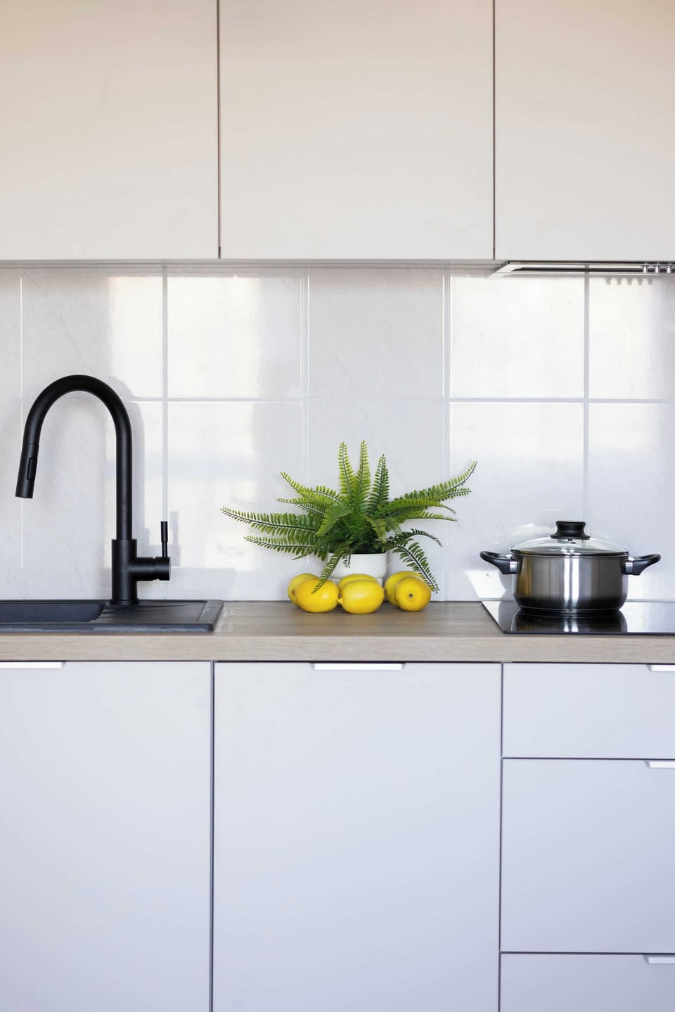 Functional and bright kitchenette with microwave, dishwasher, and electric kettle.