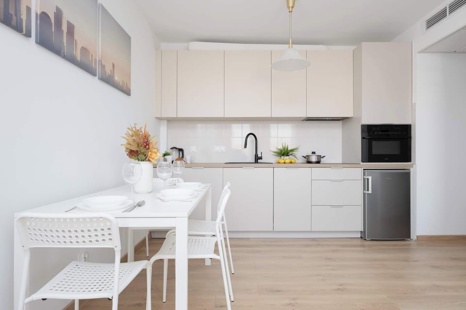 White and modern kitchenette, where the guests can use such appliances as kettle, microwave, and dishwasher.