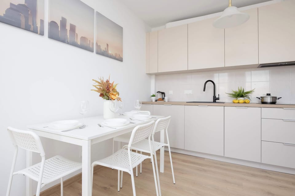 Dining area located next to the functionally equipped kitchenette with such appliances as kettle or microwave.