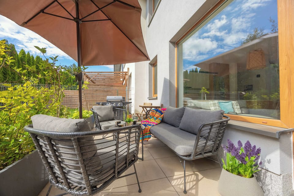 A sunny terrace with comfortable designer garden furniture - the perfect place to relax.