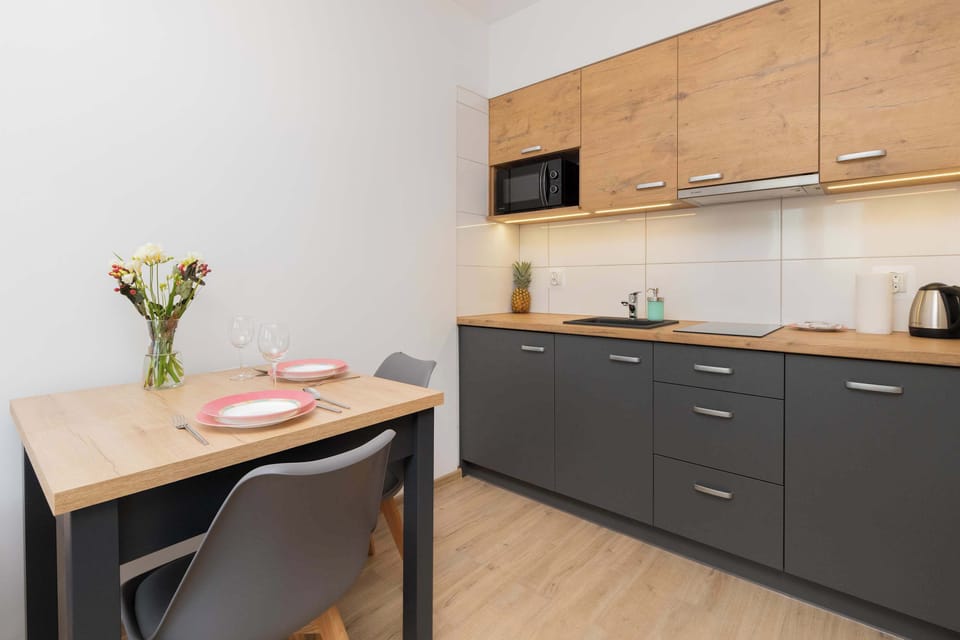 Dining table with chairs and kitchenette.