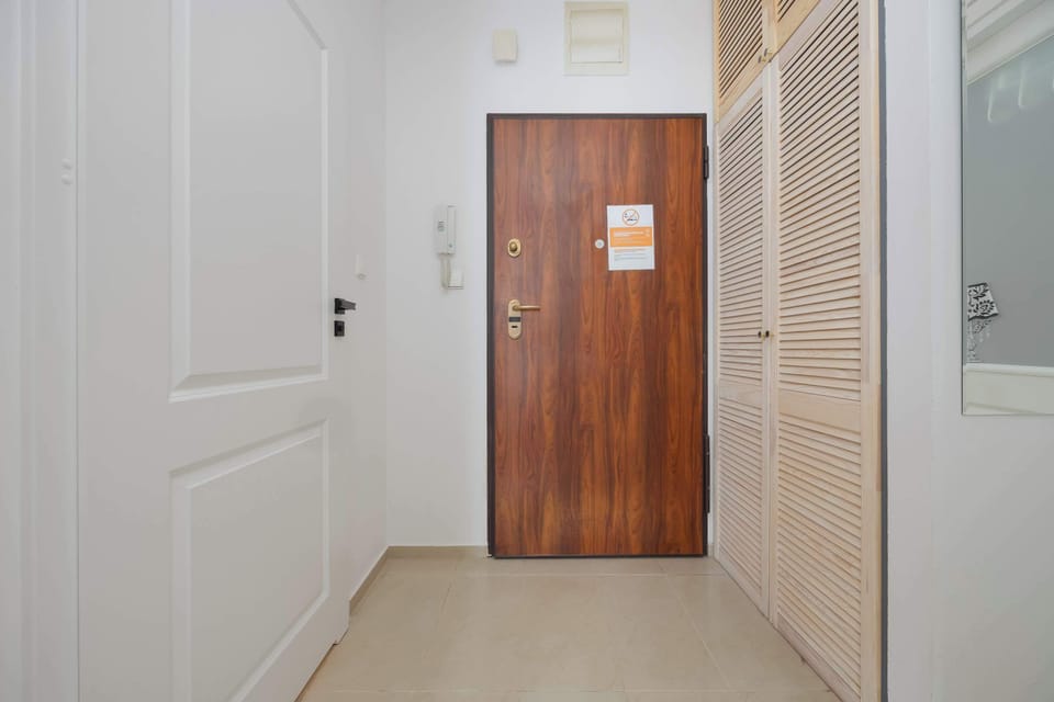 Shows the hallway and main entrance door, giving a sense of security and order.