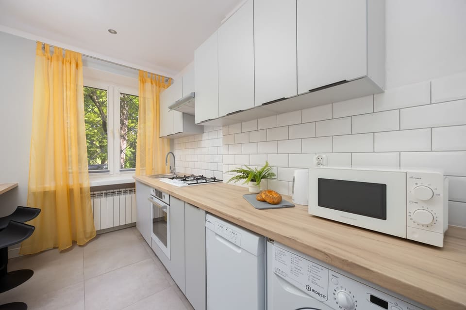 Fully equipped kitchen with gas stove, oven, microwave, dishwasher, fridge and freezer and electric kettle.