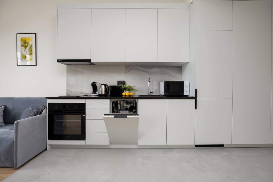 A bright kitchen with full-wall cabinetry offers convenience and a clean aesthetic.