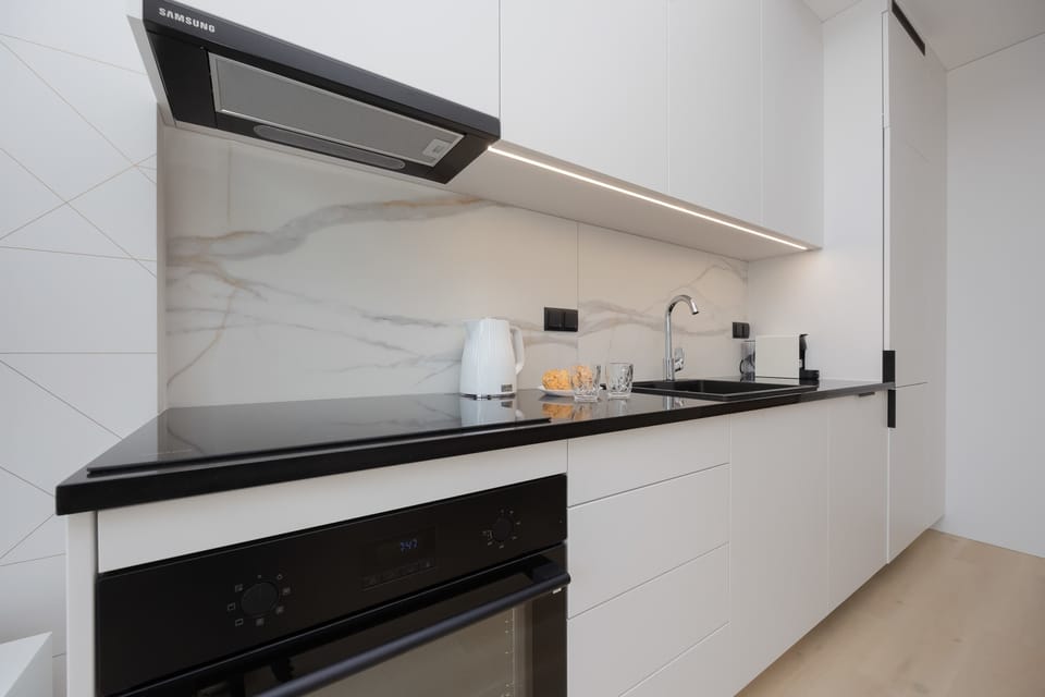 Kitchenette with plenty of kitchen utensils and dishes.