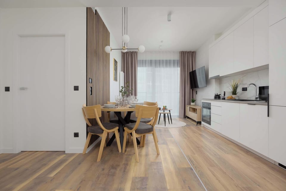 The dining area with pendant lighting and wooden flooring invites shared meals.