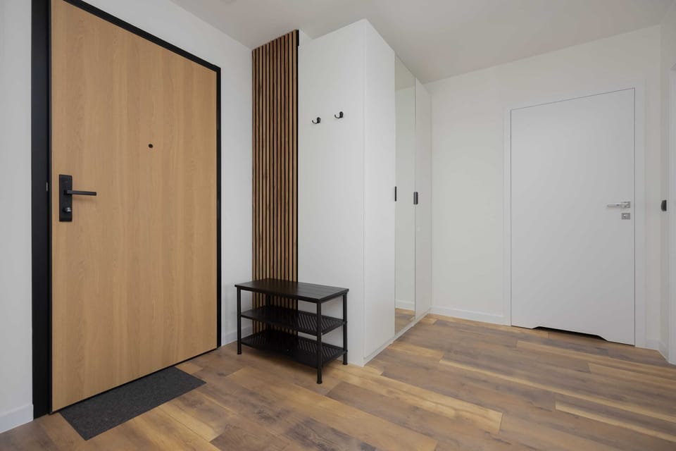 The spacious hallway with a bench and large mirror makes heading out easy and comfortable.