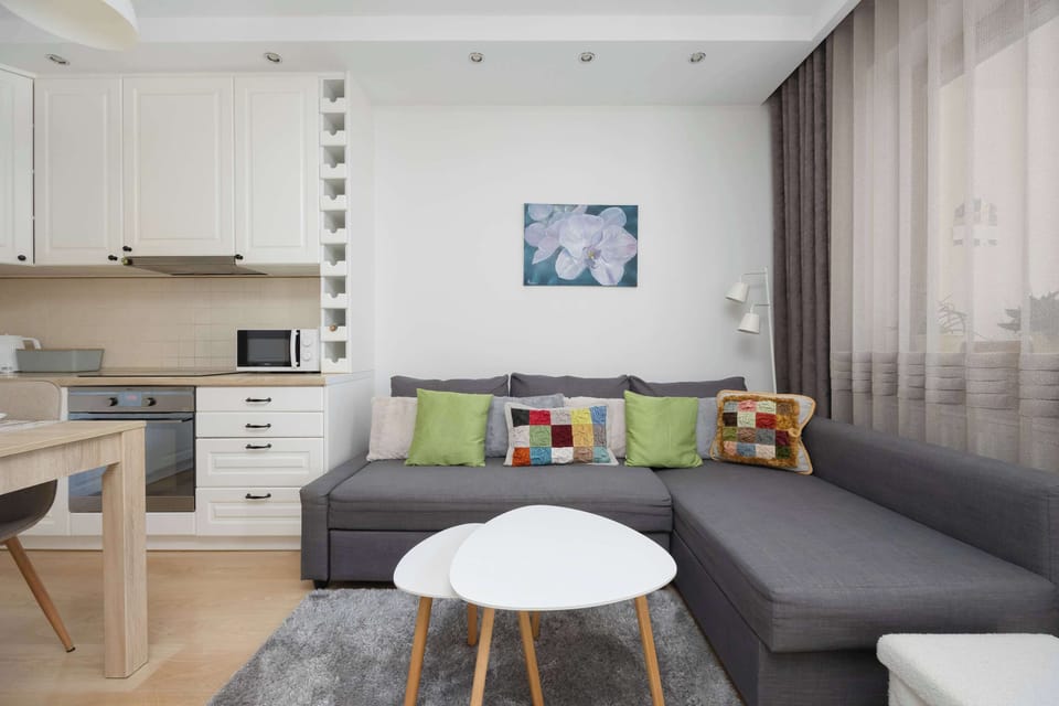 A modern living room with soft lighting, a TV, and a coffee table. Designed for both comfort and style.
