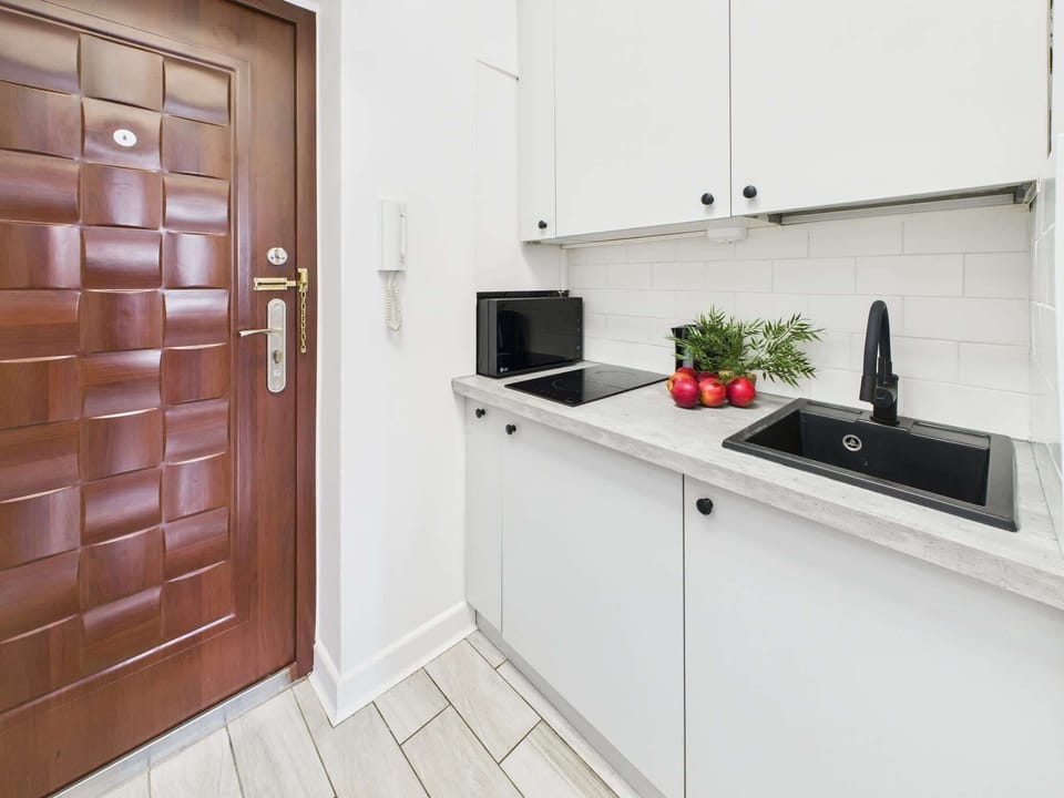 Solid front door for security and kitchenette.