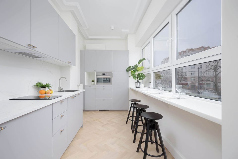 The sleek design of the kitchenette blending seamlessly with the living area.