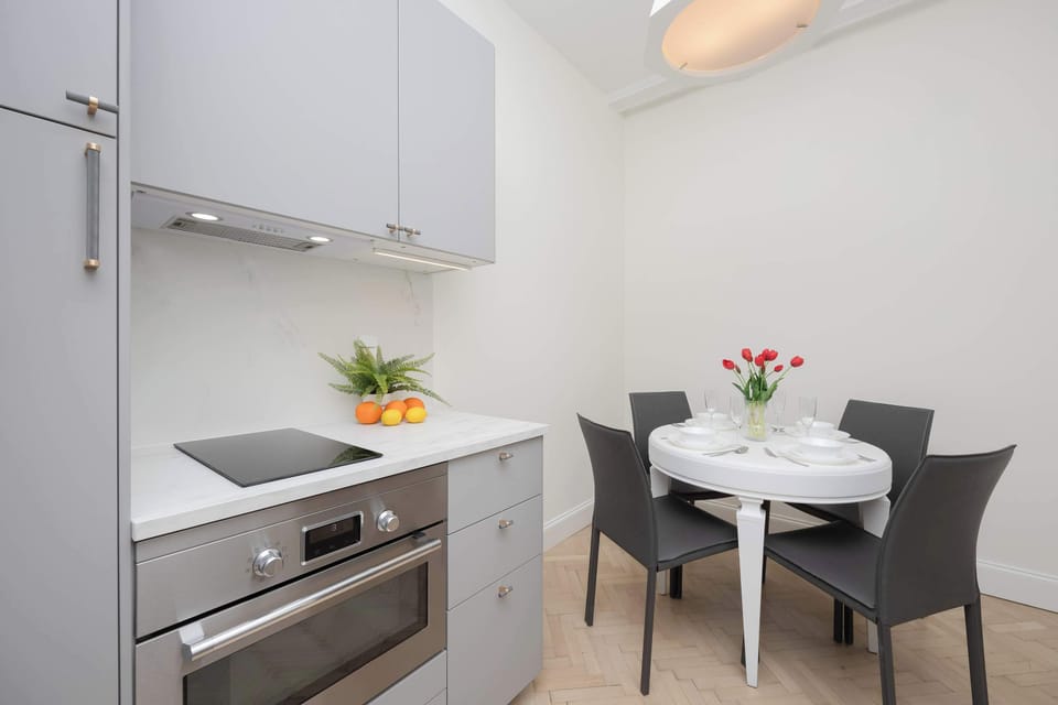 The sleek design of the kitchenette blending seamlessly with the living area.