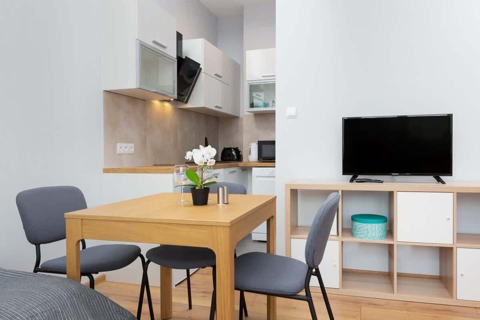 A bright corner with a small desk and chair, perfect for work or study. The room also features a comfortable seating area with colorful decor.