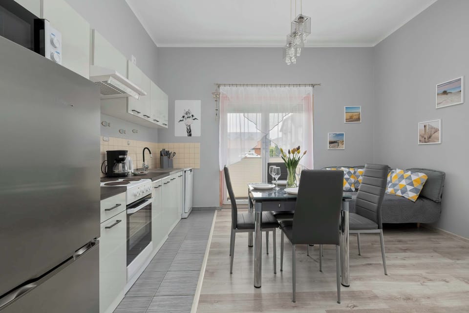 Kitchenette with plenty of kitchen utensils and dishes.