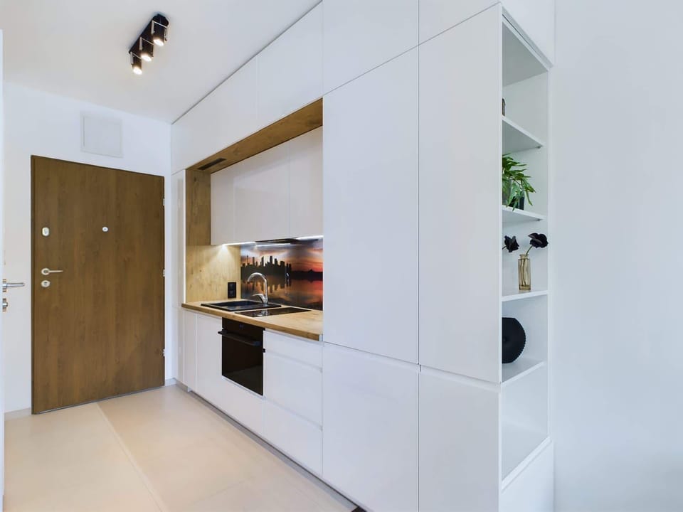 Kitchenette with oven and refrigerator.