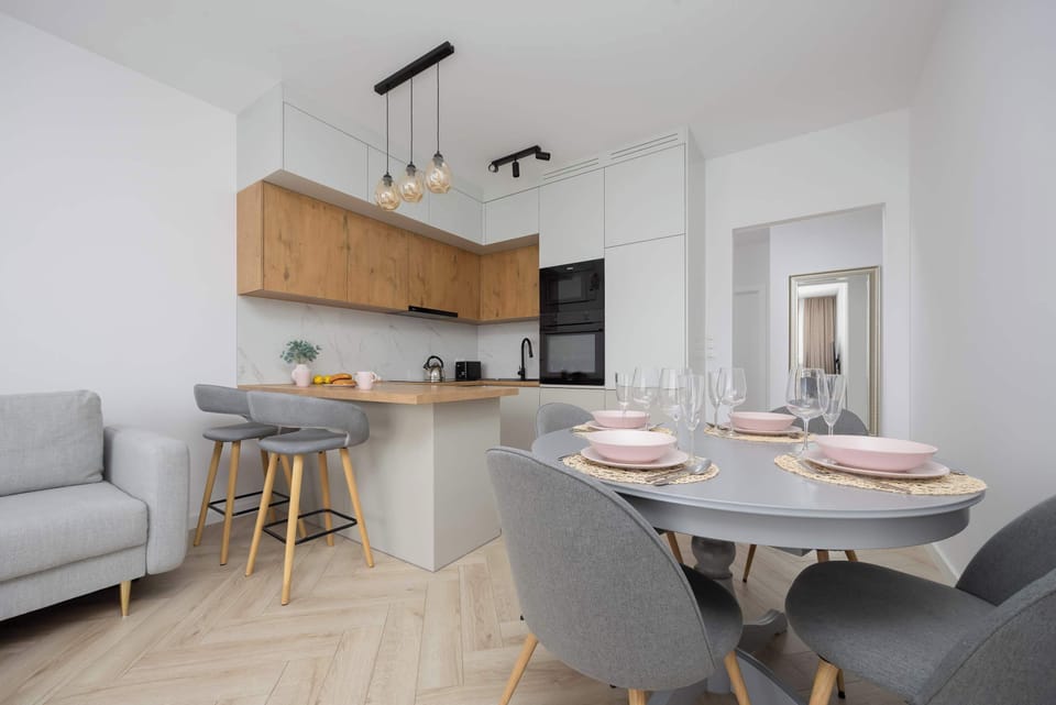 A stylish dining area with pastel tableware invites you to enjoy shared moments.