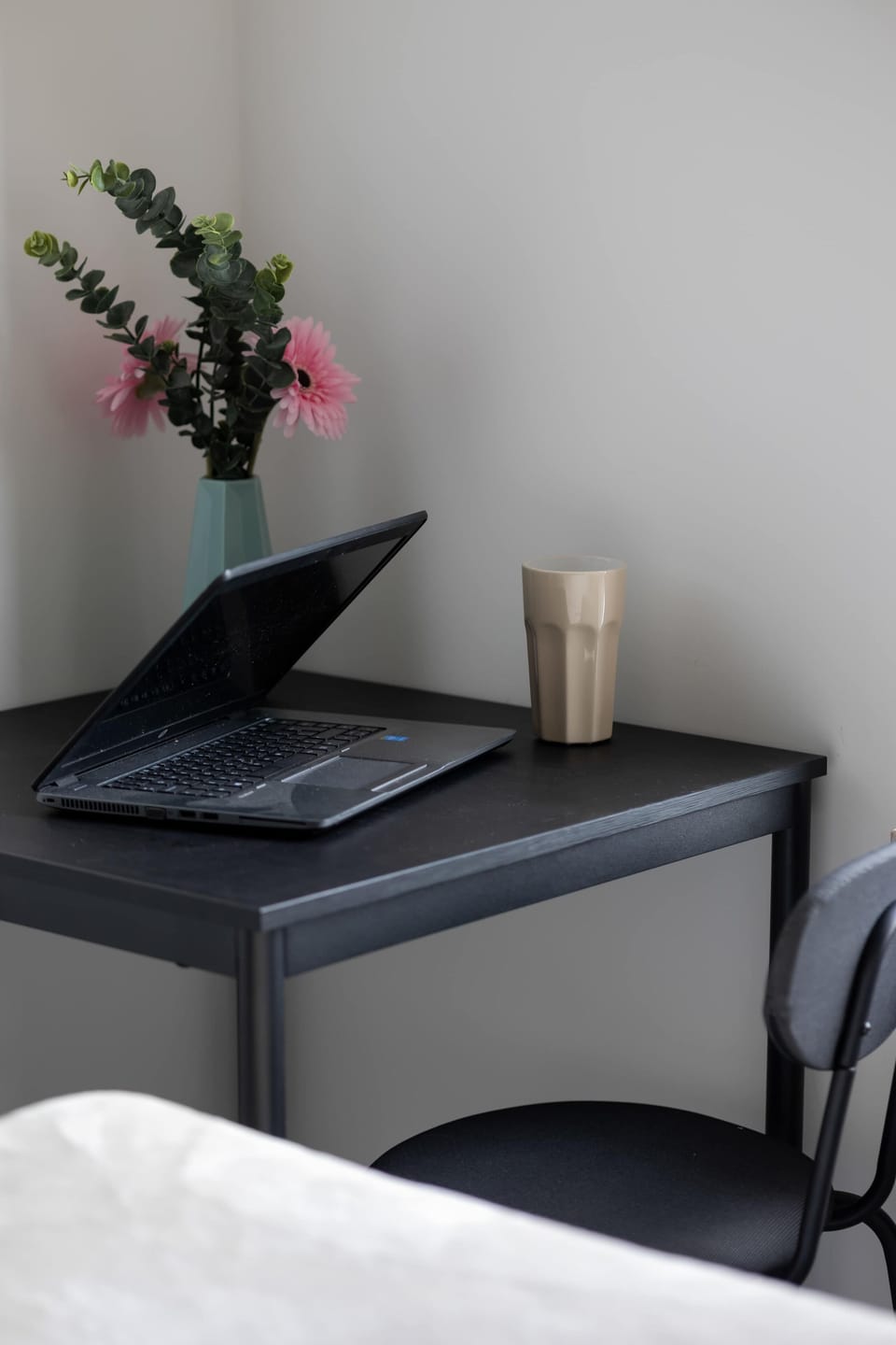 The desk in the bedroom is a compact, modern piece, perfect for work or study. Positioned near the window, it offers access to natural light, and its minimalist design complements the room's decor beautifully.