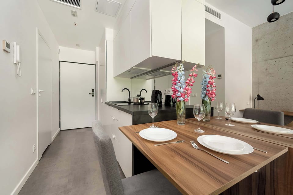 Fully equipped kitchenette with dining table and chairs.