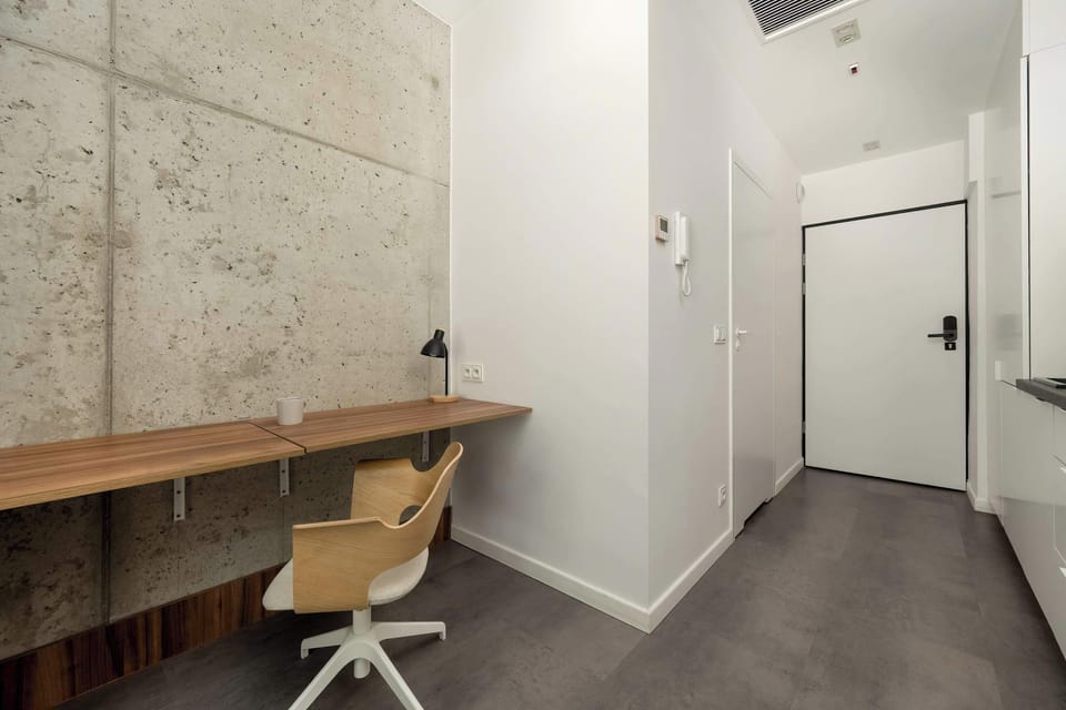 Studio space with desk and a chair for remote work.