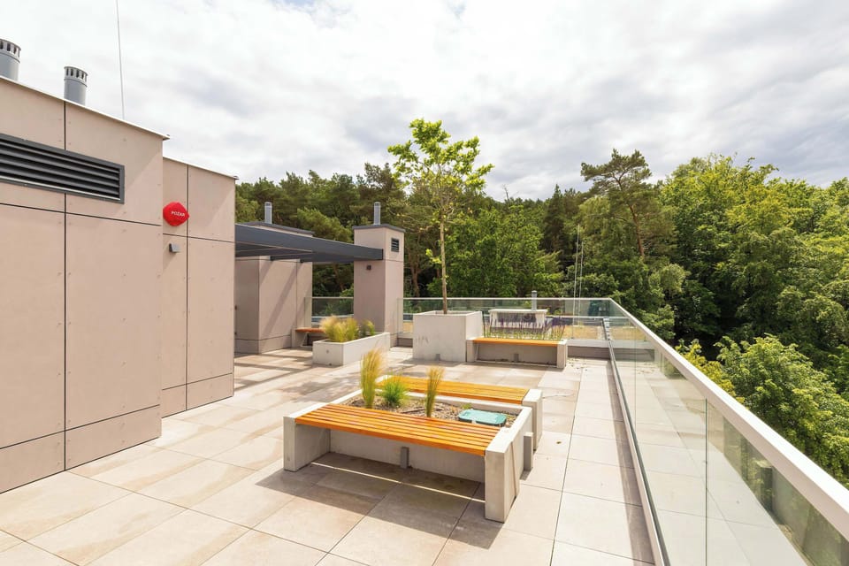 A stylish rooftop terrace with outdoor furniture and plants. A perfect place for socializing or enjoying solitude.