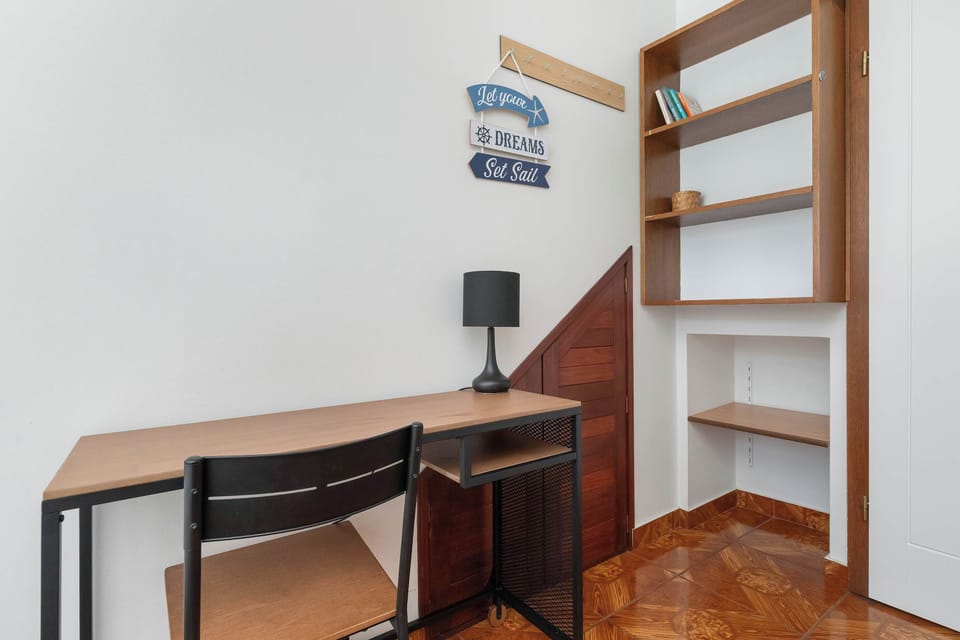 A practical workspace with a desk and chair, placed by the window for natural light – ideal for studying or remote work.
