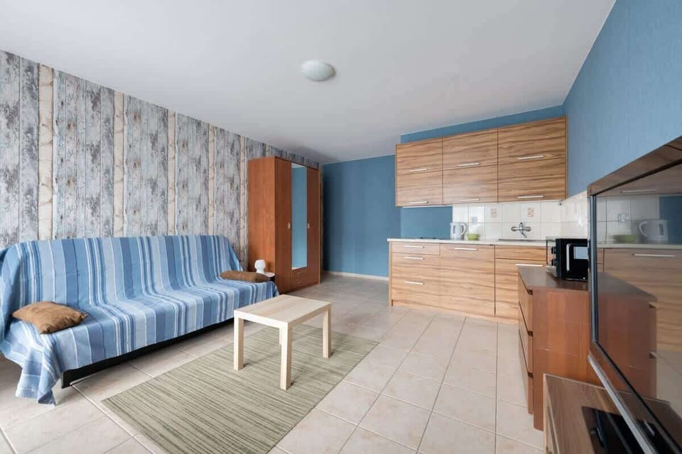 There is a TV with cable programs, a chest of drawers and a coffee table. 