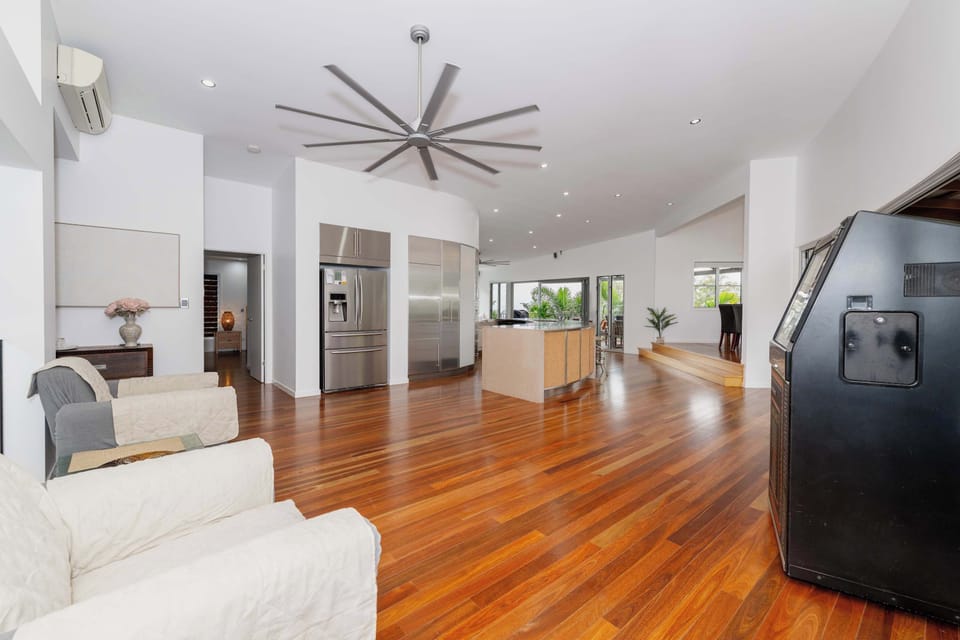 Open plan living and dining area with timber floors