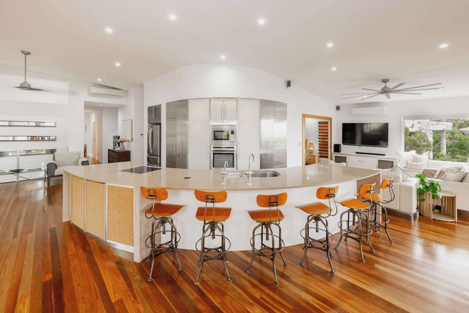 Large modern kitchen with island bench and bar stools