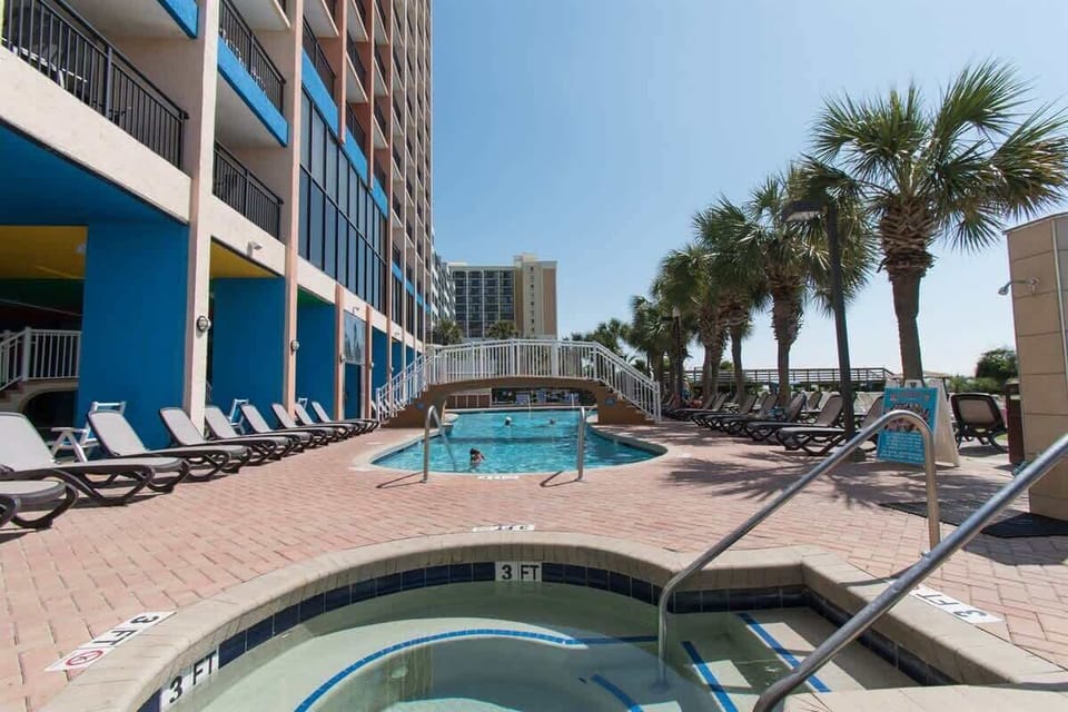 - Resort pool and hot tub with palm trees and sunny deck   - Relax in loungers or enjoy a swim just steps from beach   - Perfect for families looking for fun and relaxation
