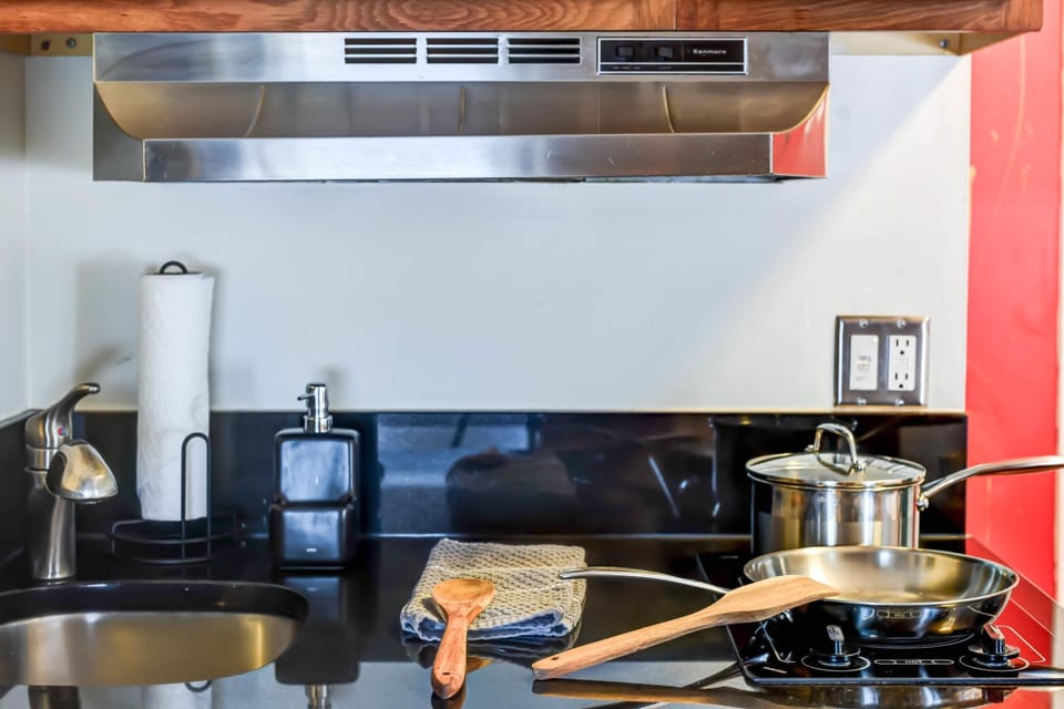 Fully equipped kitchenette with stovetop and essentials for cooking.