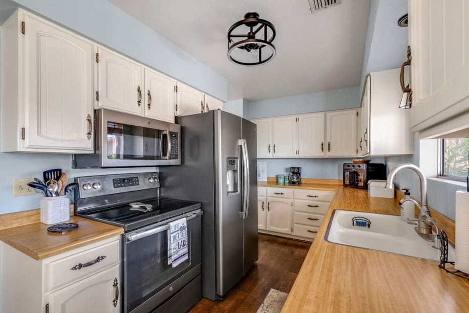 Fully equipped kitchen with drip coffee maker and stainless appliances.