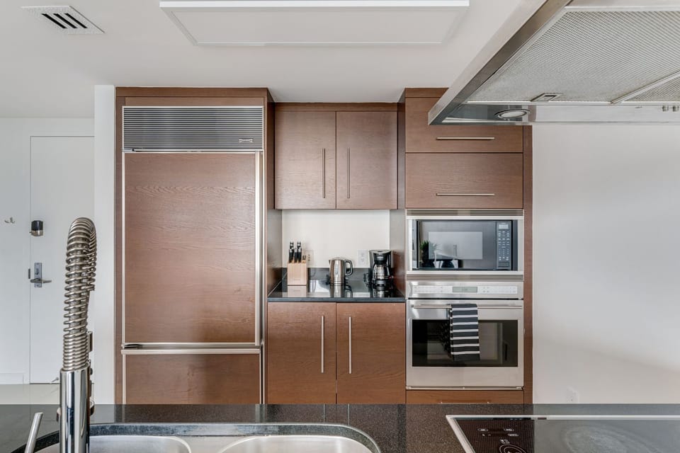 Fully equipped modern kitchen with stainless steel appliances.