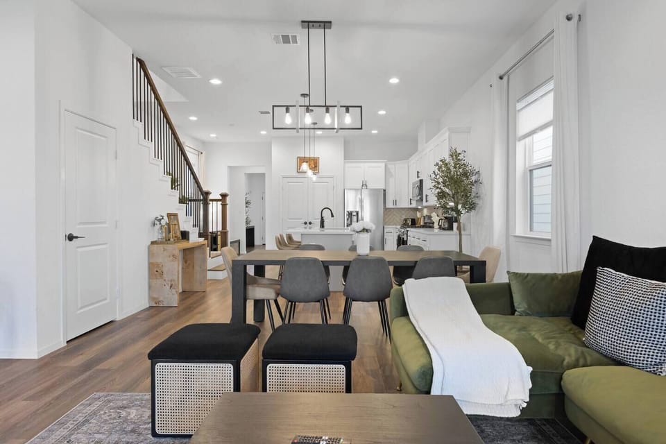 Living & Dining Area: Bright and airy space featuring a chic dining table and stylis.Living & Dining Area: Spacious open-concept space with a cozy sectional, large dining table for 8–10 guests, ceiling fan, air conditioning, and smart TV for entertainment.
