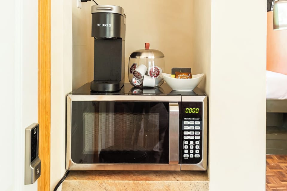 Microwave and coffee maker for your convenience.