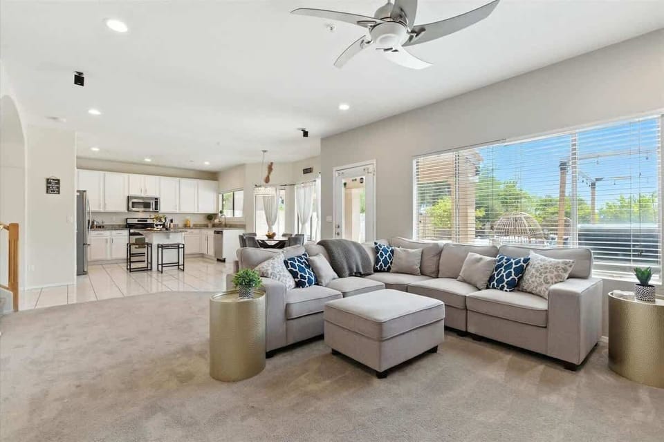 Open bright open floor living space featuring a smart TV, large sectional, and thoughtfully furnished with comfort in mind. Fireplace for display only. (1st Floor)