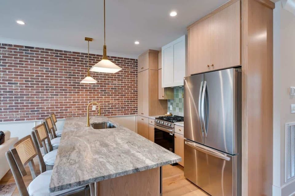 2nd Floor: Fully equipped kitchen with stainless steel appliances and bar seating for 3 guests.