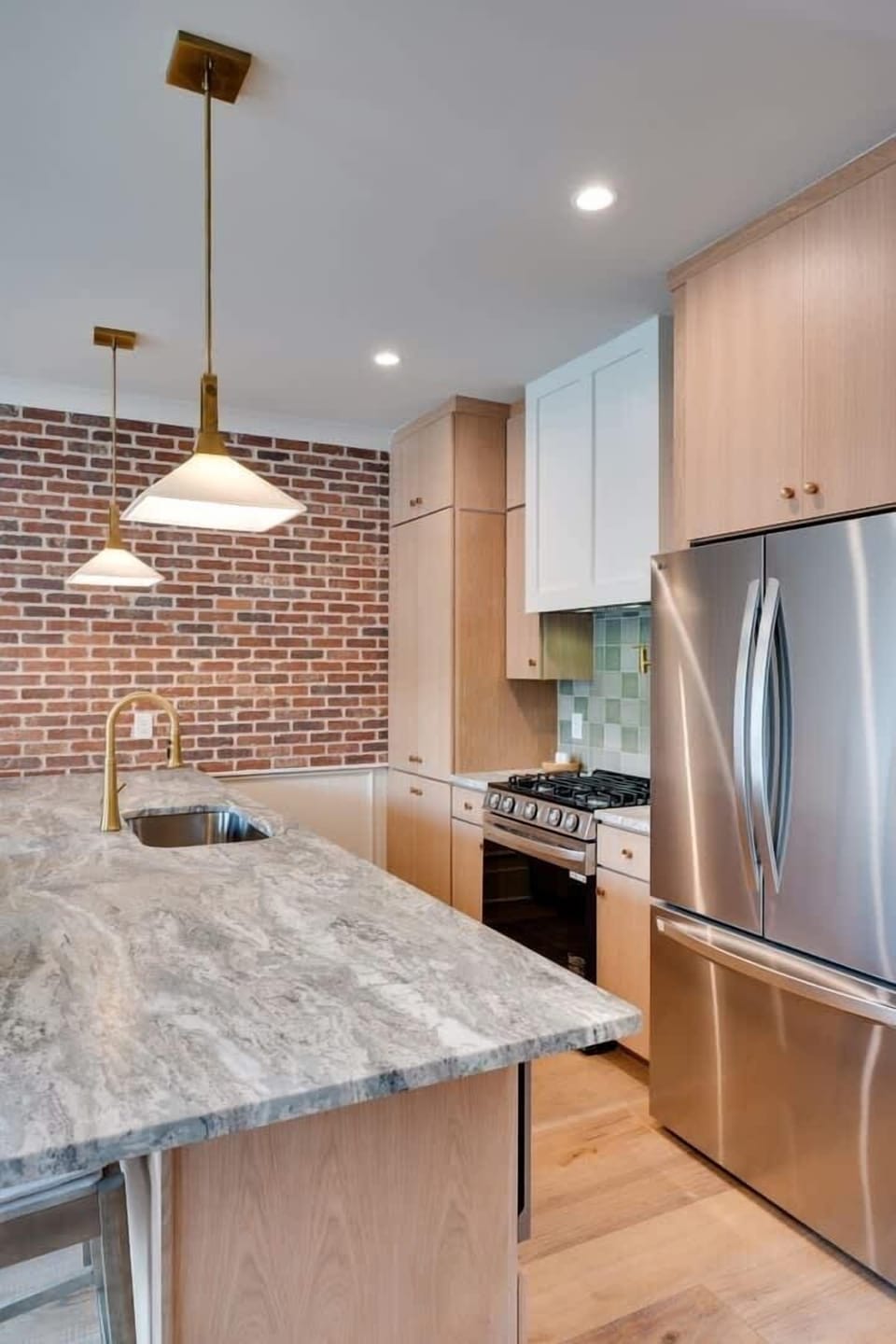 2nd Floor: Fully equipped kitchen with stainless steel appliances and bar seating for 3 guests.