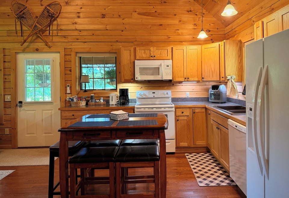 Eat-in kitchen with total of six padded stools available. (Front door on left)