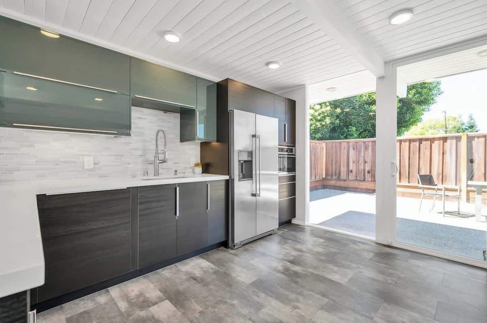 Floor-to-ceiling windows illuminate the Kitchen with natural light.