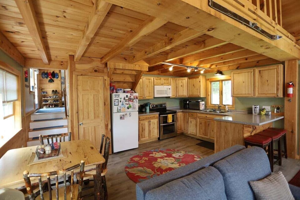 Fully equipped kitchen and dining area with breakfast bar in a house  on Stinson Lake in the White Mountains