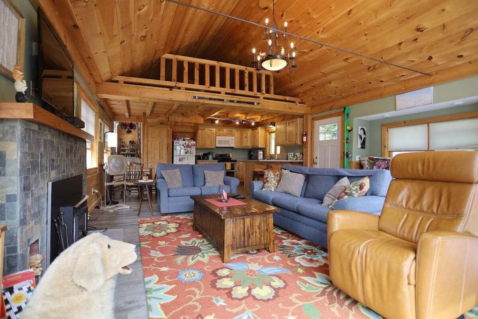 Cozy living room with TV and deck accessin a lake house on Stinson Lake in the White Mountains