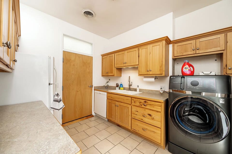 Kitchen and laundry placed together for everyday convenience.